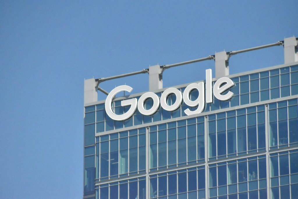 A tall building with the google logo on top of it