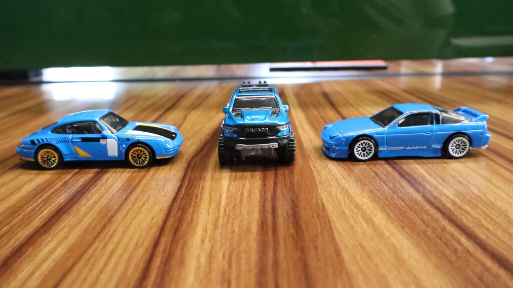 A group of toy cars sitting on top of a wooden floor