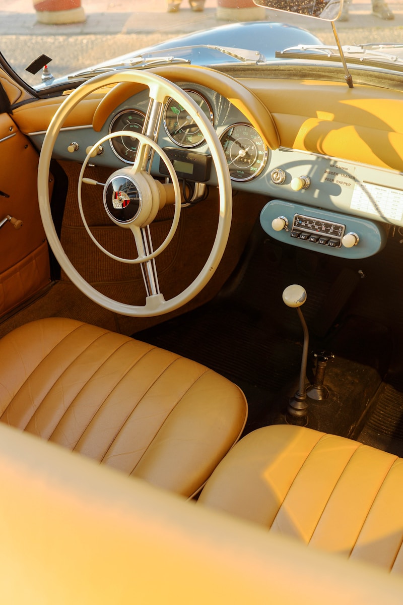 The interior of a car with a steering wheel and dashboard