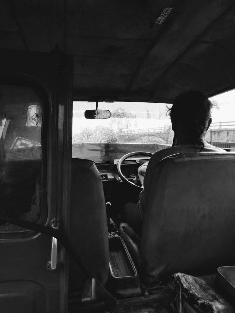 a man sitting in the driver's seat of a truck