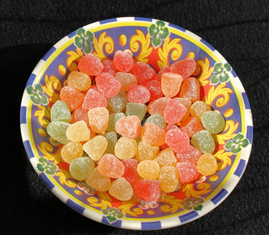 a bowl filled with gummy bears on top of a table