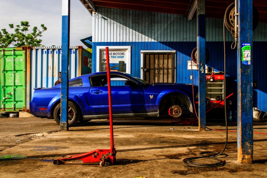 a blue car parked in front of a building