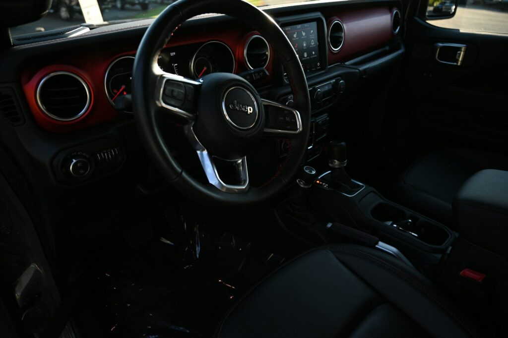 the interior of a car with a steering wheel and dashboard