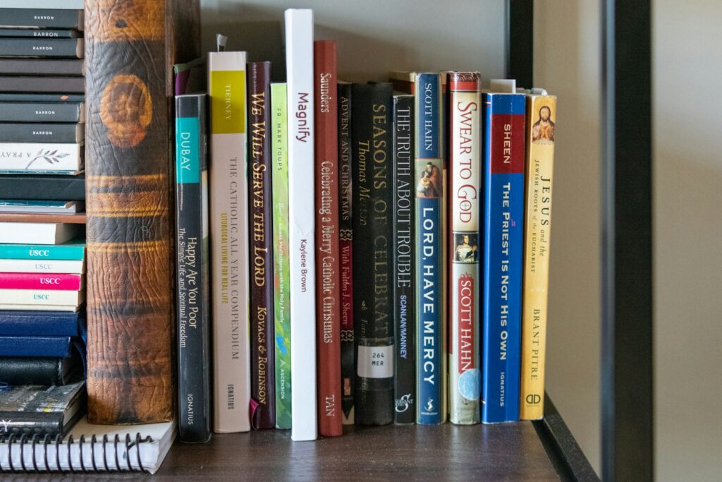 A bookshelf filled with lots of books on top of a wooden table