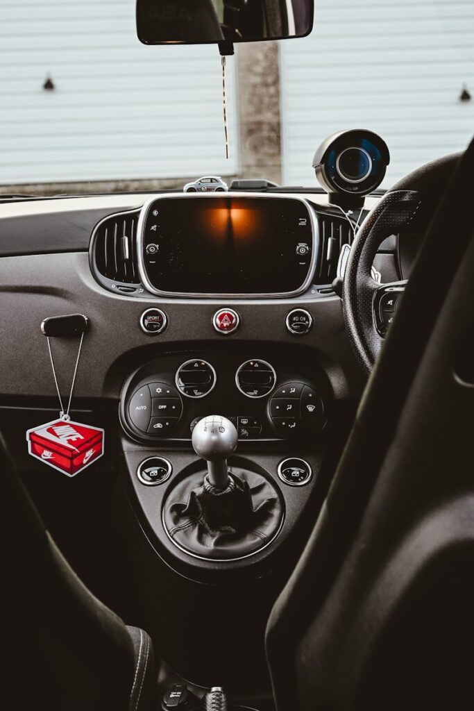 The dashboard of a car with a camera mounted to it's side