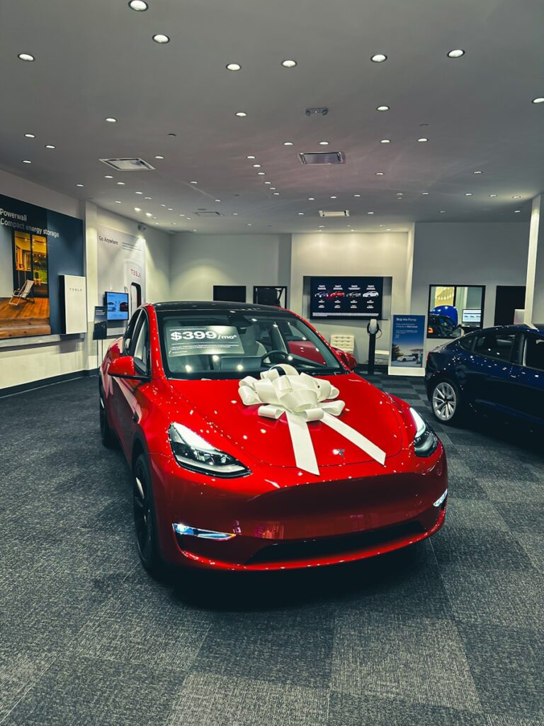 a red car with a white bow on it