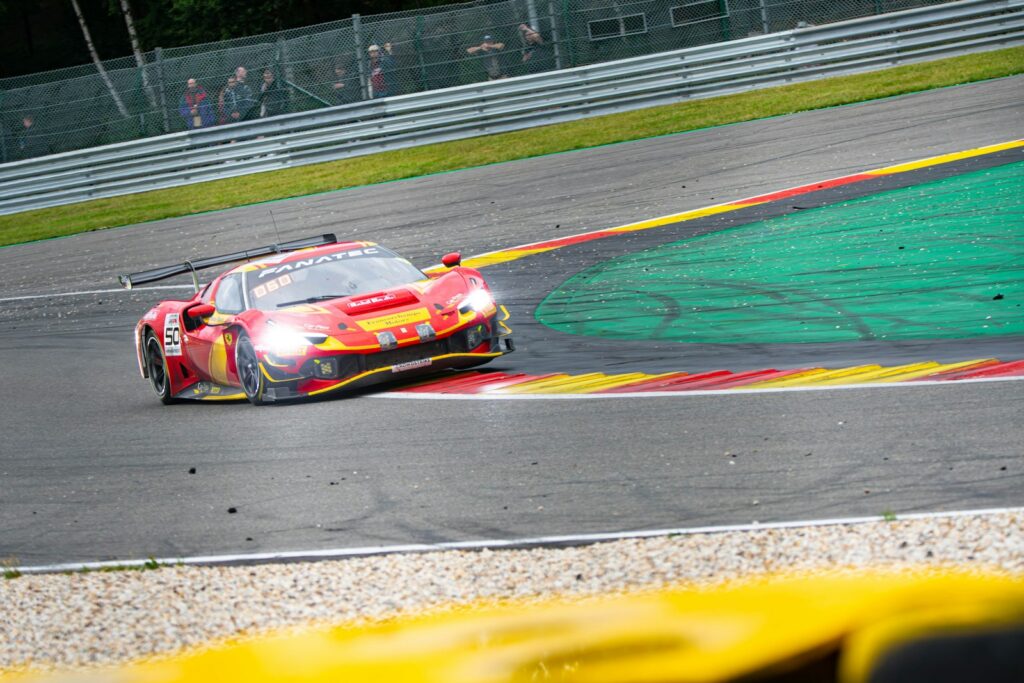 a red sports car driving on a race track