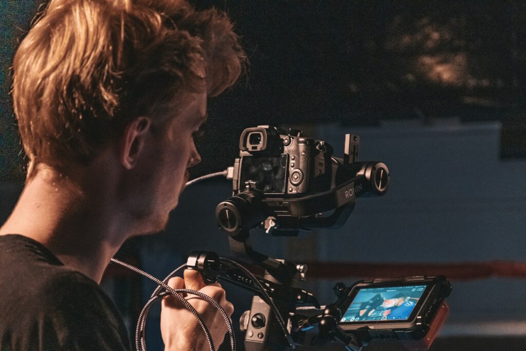 man in black shirt using video camera