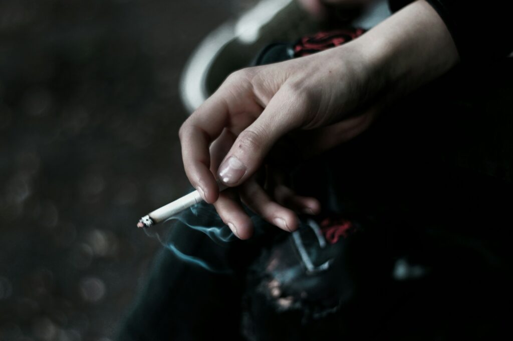A person holding a cigarette in their hand