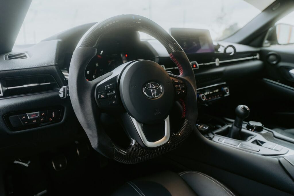 The image shows the interior of a toyota supra.