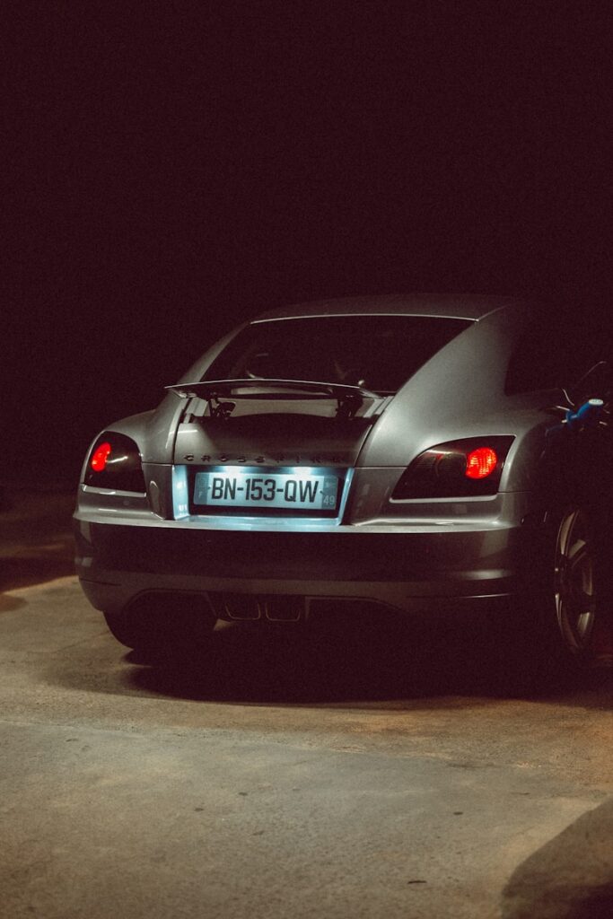 A car parked in a parking lot at night