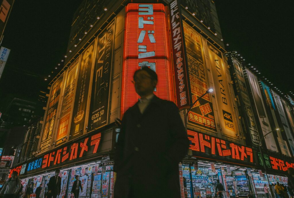 A man standing in front of a building at night