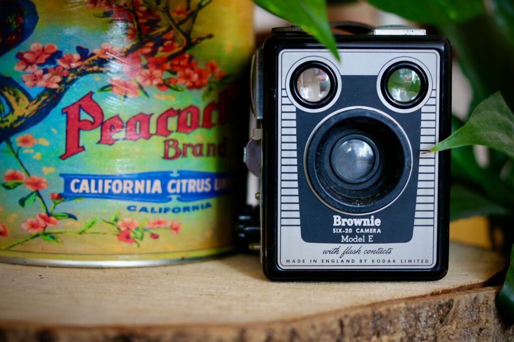 a camera sitting on top of a wooden table next to a can
