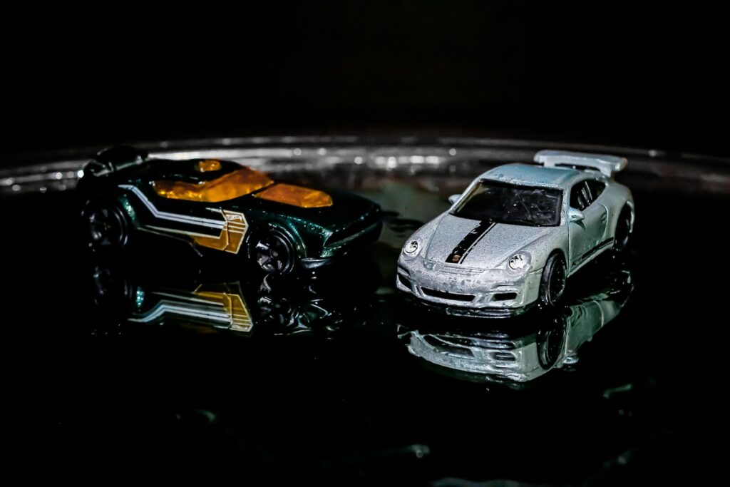 Two toy cars sitting on top of a table