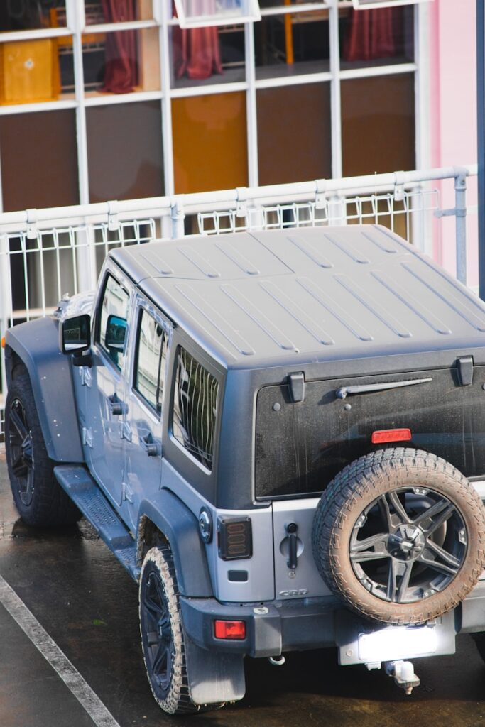 grey jeep wrangler parked on parking lot during daytime