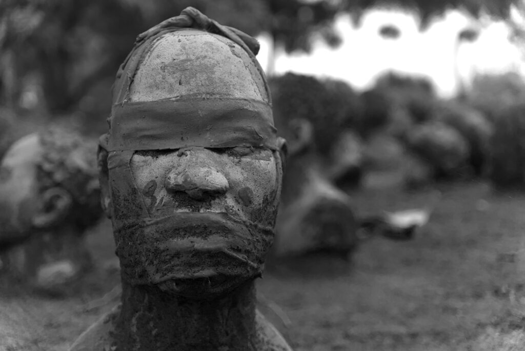 A close-up of a head with eyes and mouth covered.