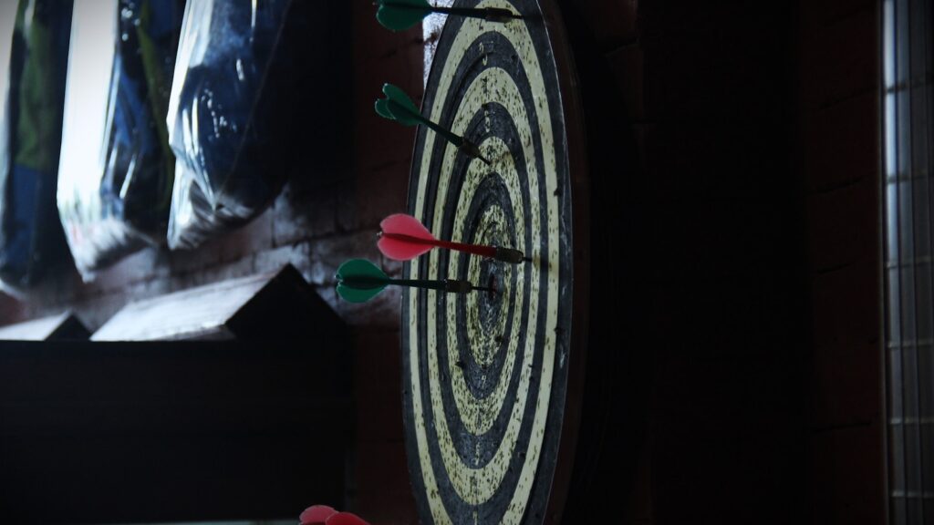 a close up of a clock with arrows on it