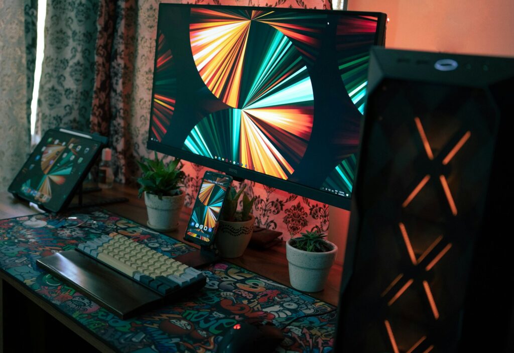 black flat screen tv turned on near black computer keyboard