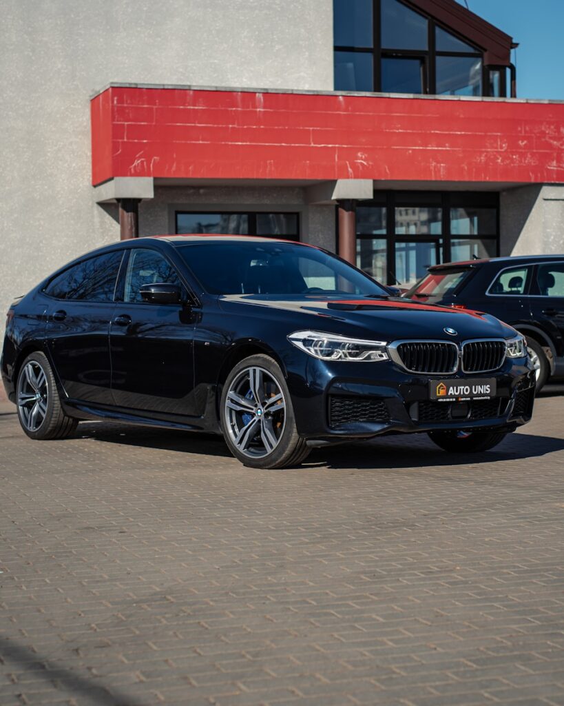 a black car parked in front of a building