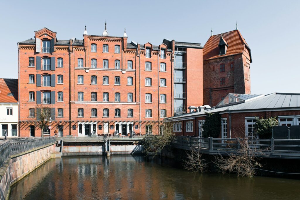 A brick building stands along a canal.