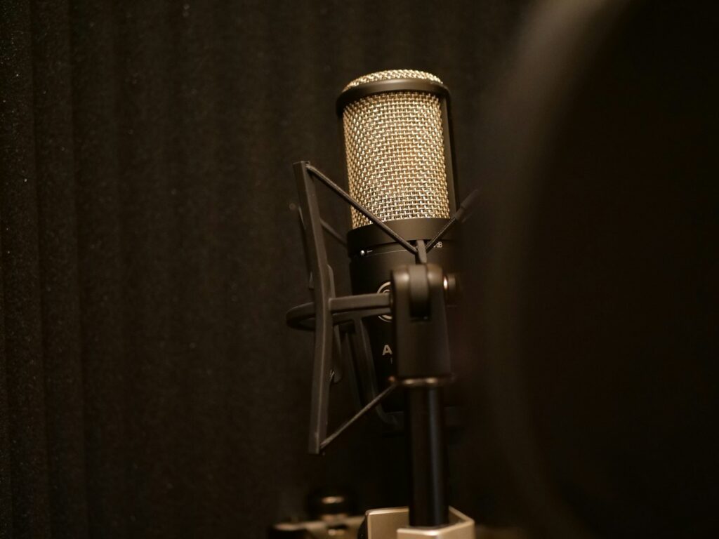 black and silver microphone on black textile