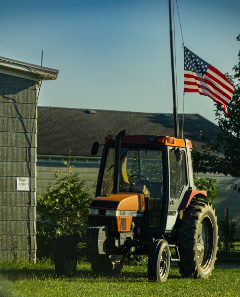 Tractor with american flag on a sunny day.