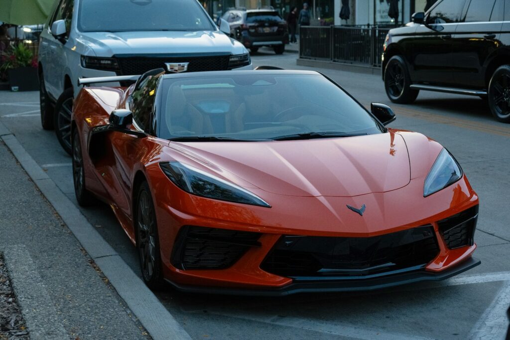 Orange sports car parked on city street