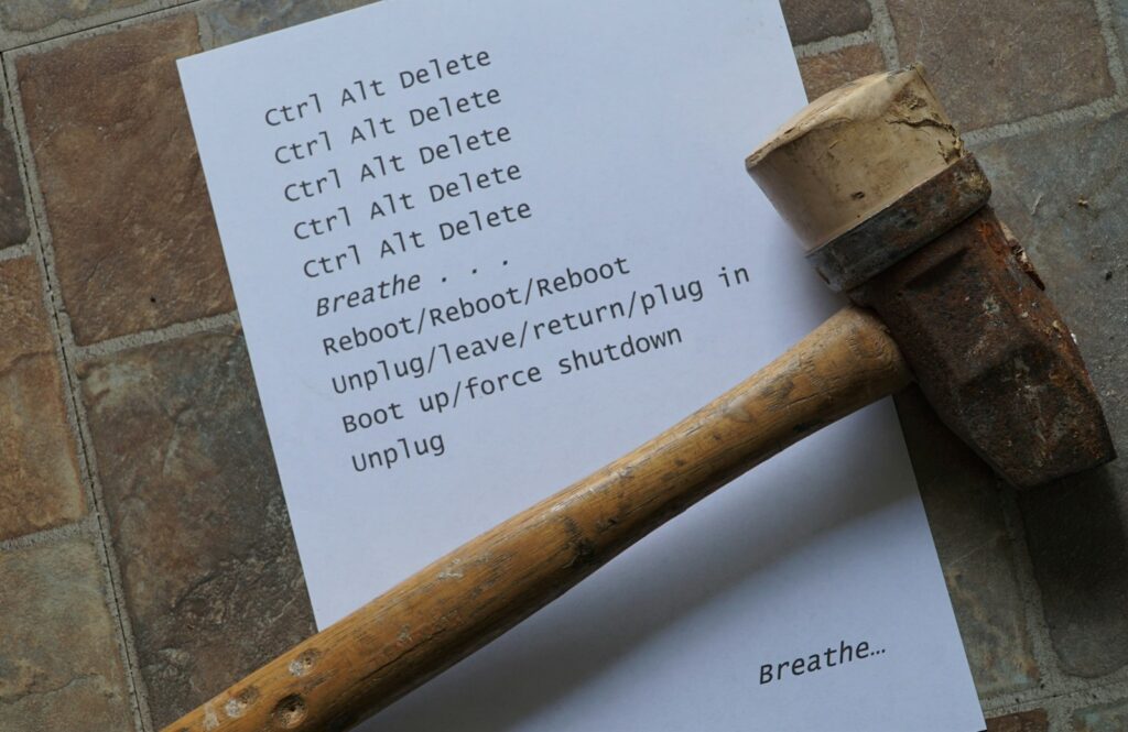 a hammer and a piece of paper on a brick floor