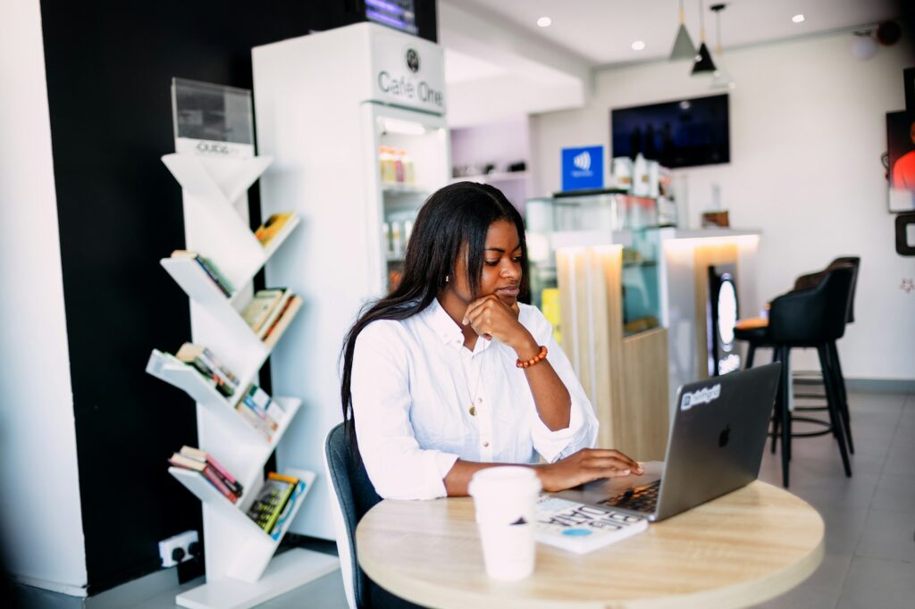 A woman sitting at a table with a laptop