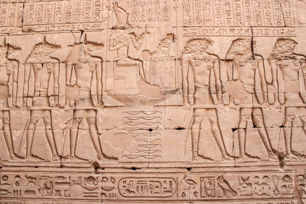 a wall with a bunch of ancient egyptian art on it