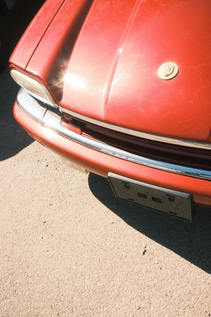 a close up of the front end of a red car