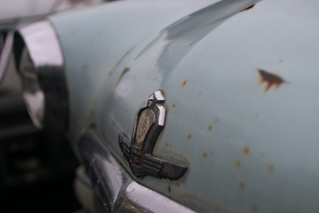a close up of a car door handle with rust