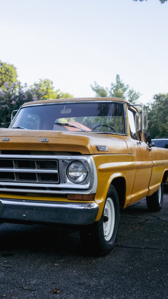 A yellow pickup truck parked in a parking lot