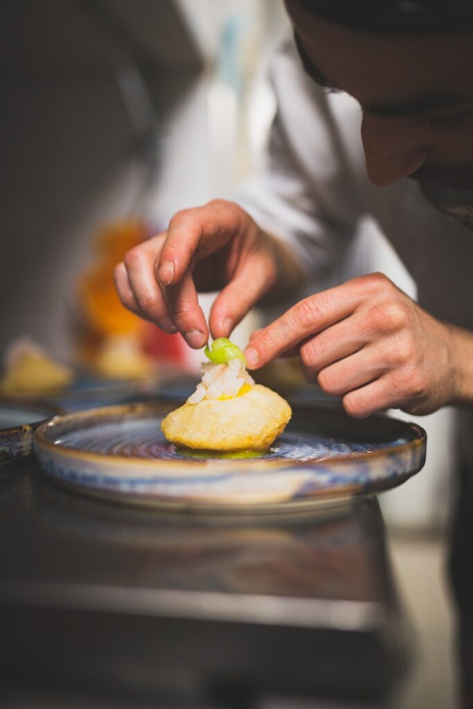person holding a pie on a round plate