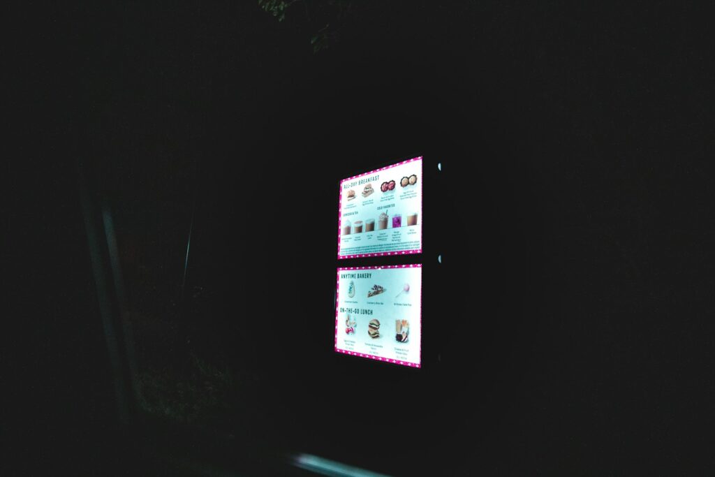 a dark room with two screens on the wall