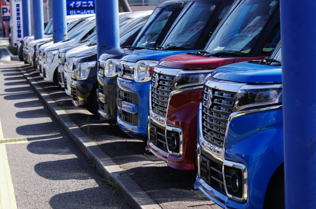 blue and silver cars on parking lot during daytime