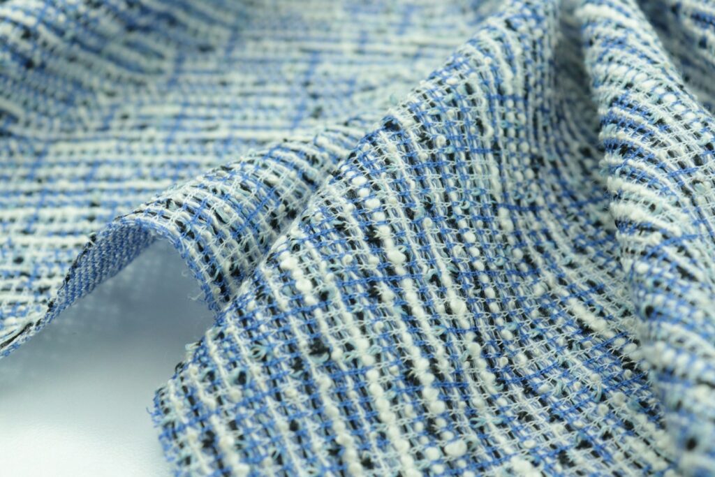 a close up of a blue and white tweed fabric