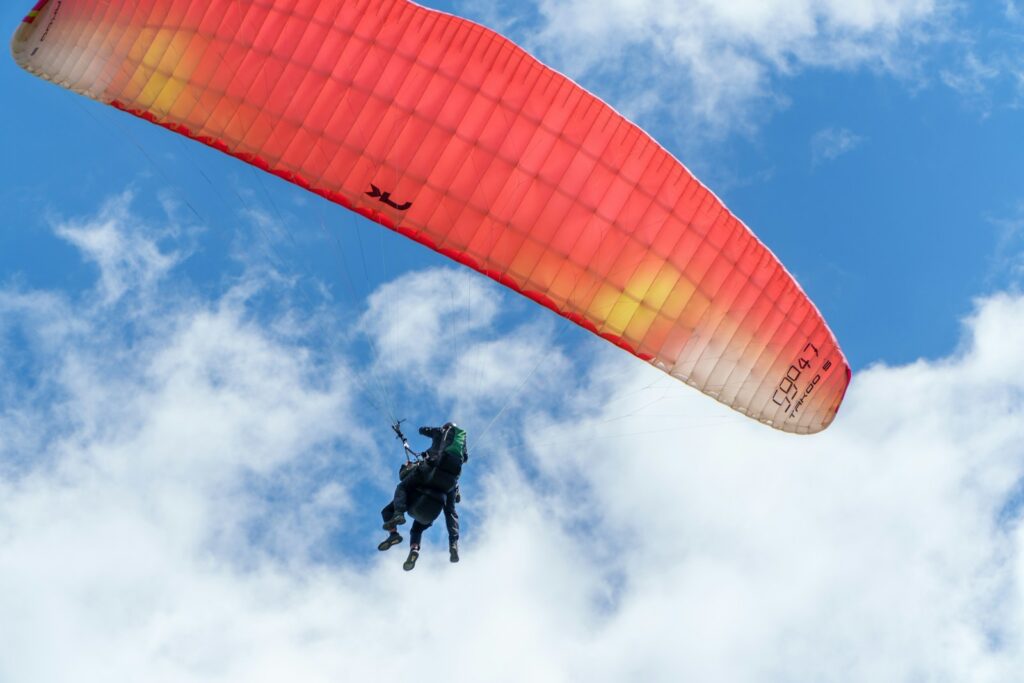 A person is paragliding high in the sky.