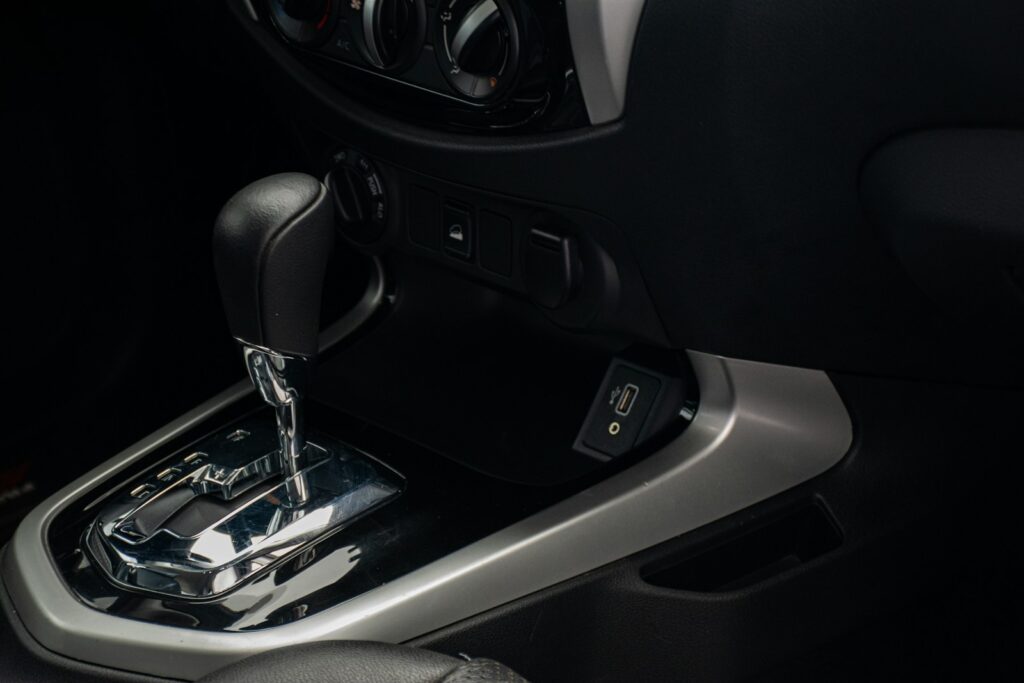 a close up of a car's gear box and steering wheel