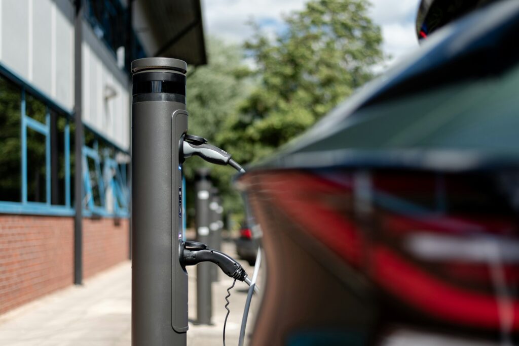 An electric car is charging at a charging station.