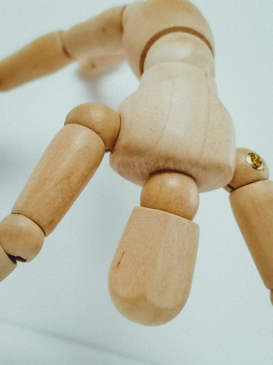 brown wooden human figure on white surface