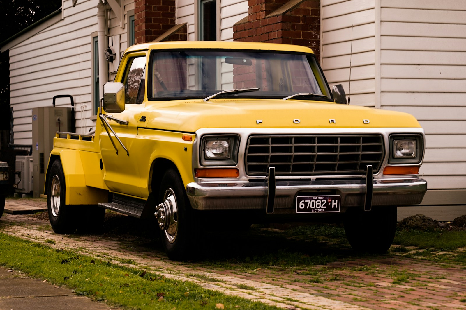 a yellow truck parked in front of a house