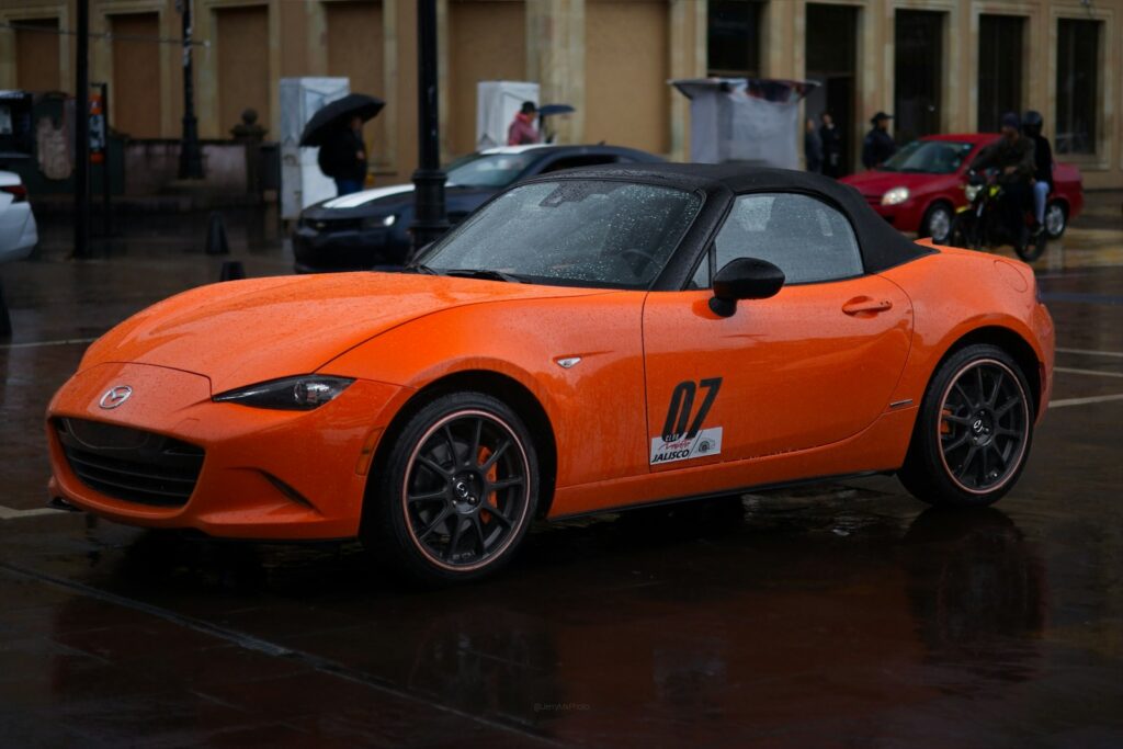 Orange convertible sports car with number 07 on side.