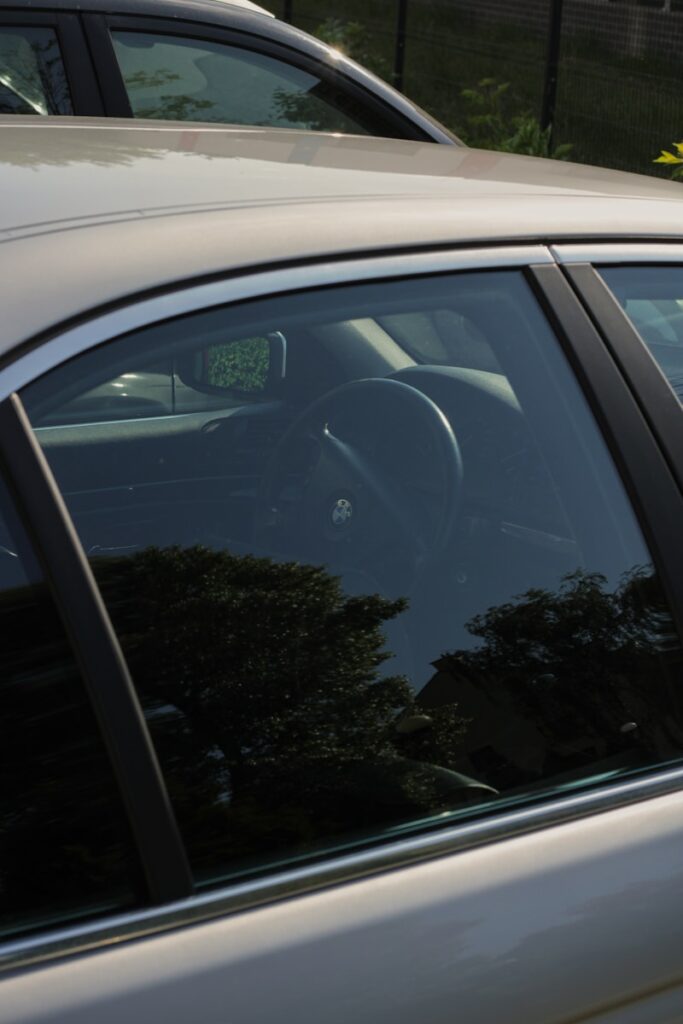 a white car parked in a parking lot next to another car