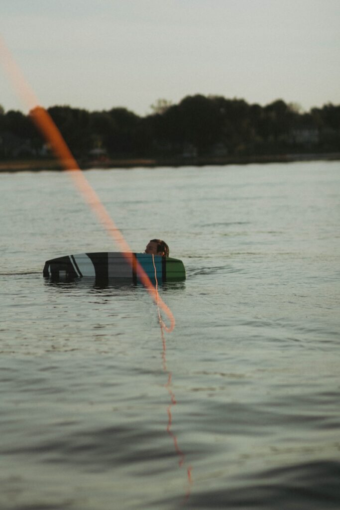 a person in a body of water with a surfboard