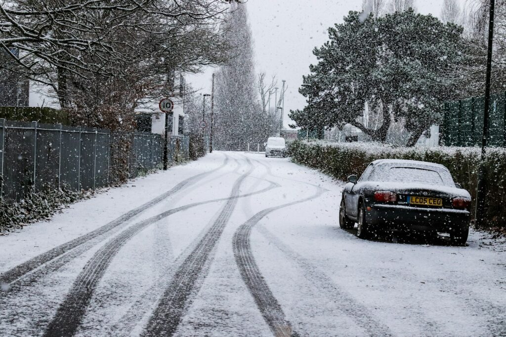 a car is parked on a snowy street