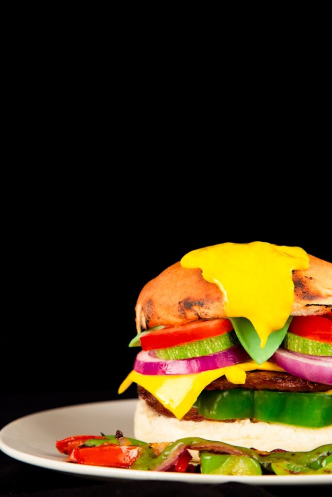 a large sandwich on a white plate on a black background
