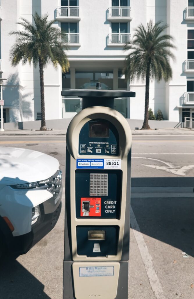 A parking meter sitting next to a parked car