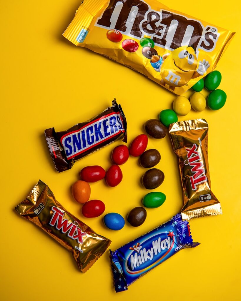 A variety of candy on a yellow background