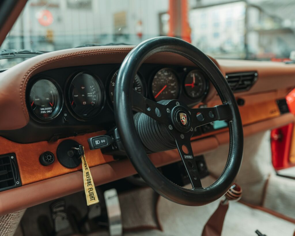 Vintage car interior with leather and wood trim.